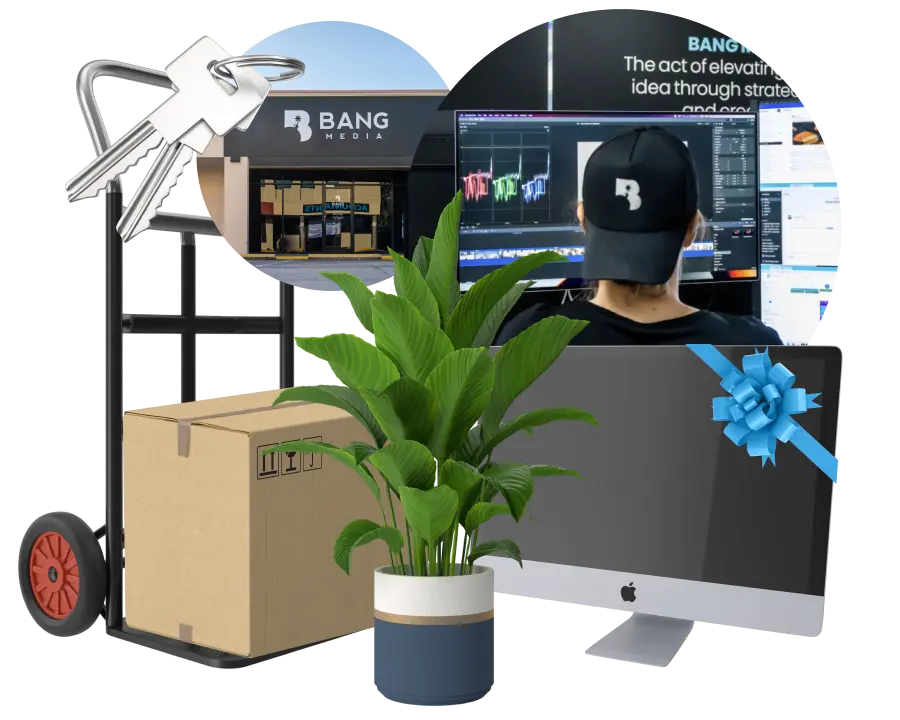 A computer monitor sitting next to a plant and a box
