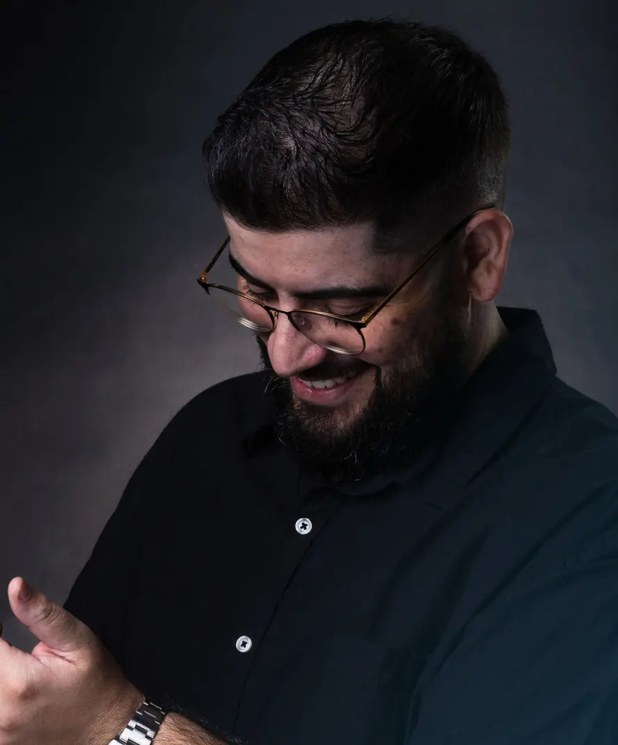 A man wearing glasses and a black shirt