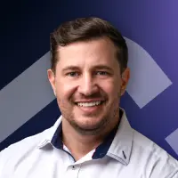 A man in a white shirt is smiling