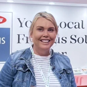 A woman standing in front of a sign