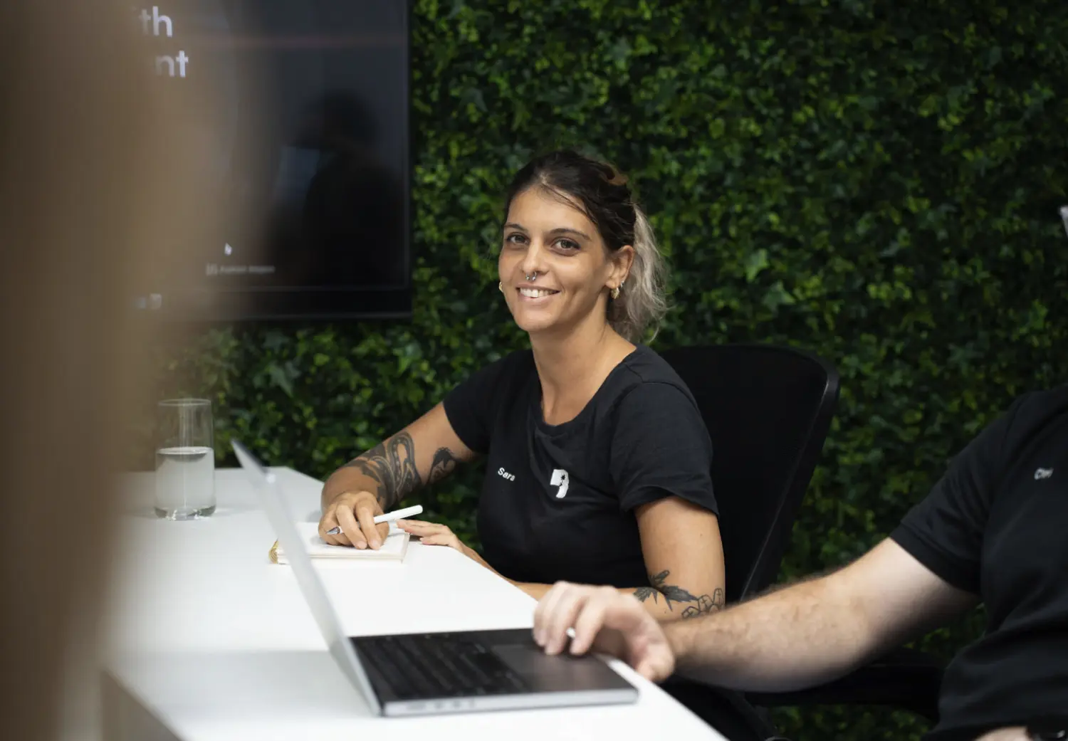 A woman sitting at a desk with a laptop