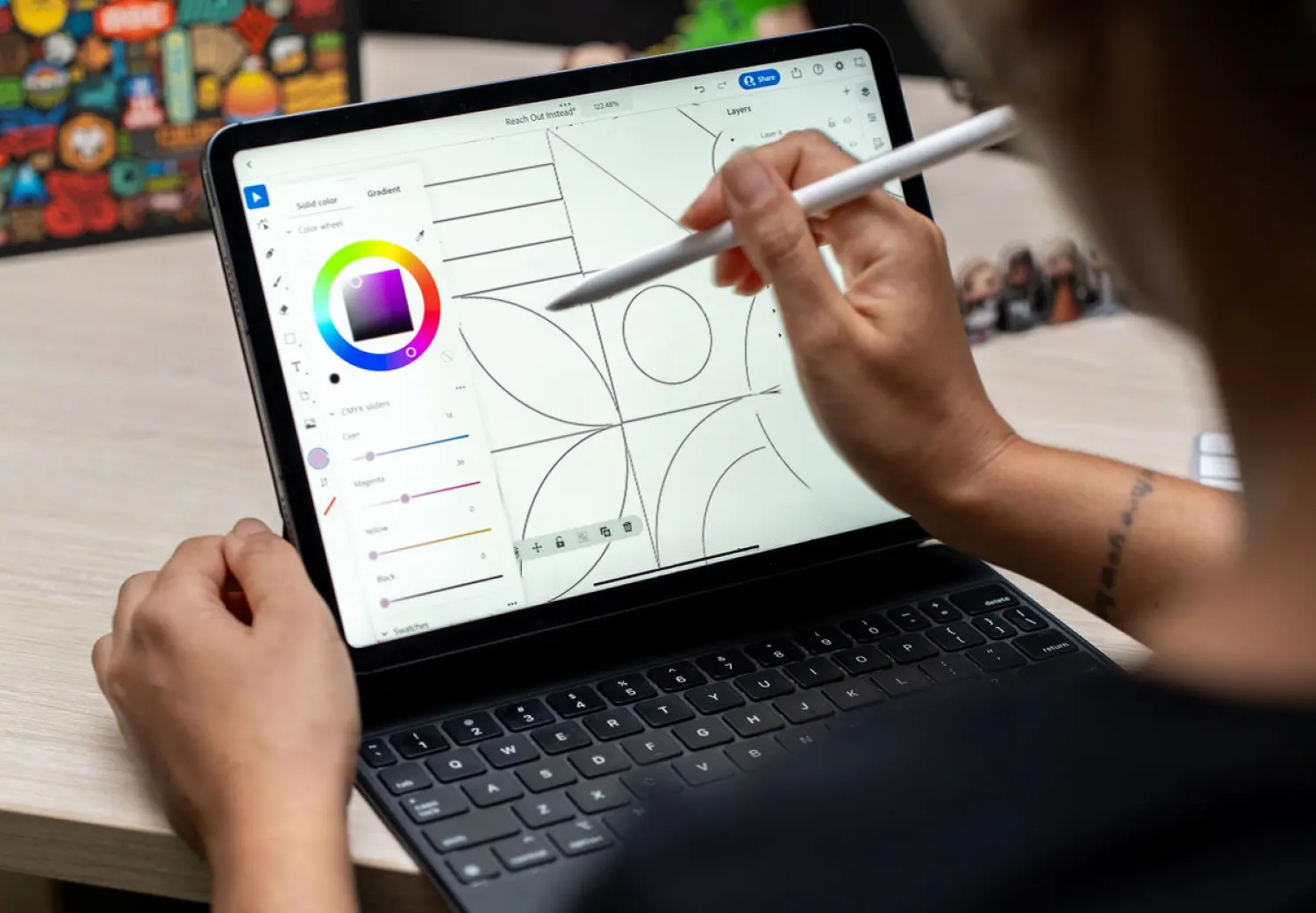 A woman is drawing on a laptop screen