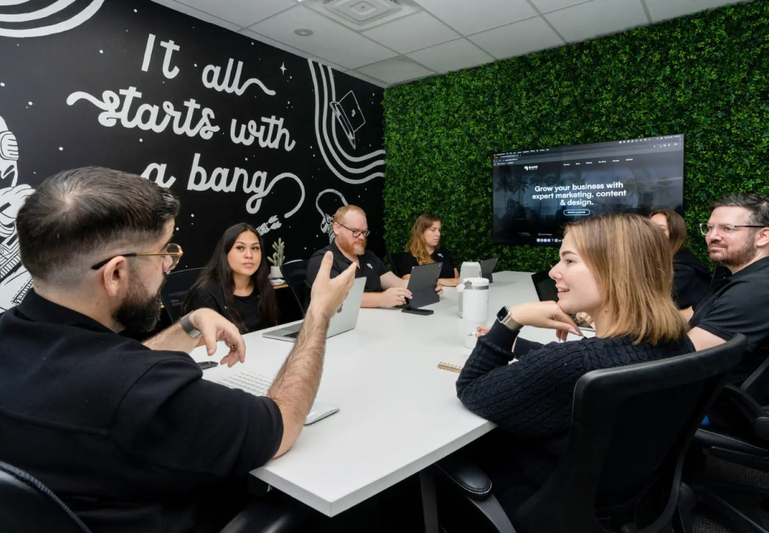 A group of people sitting around a white table