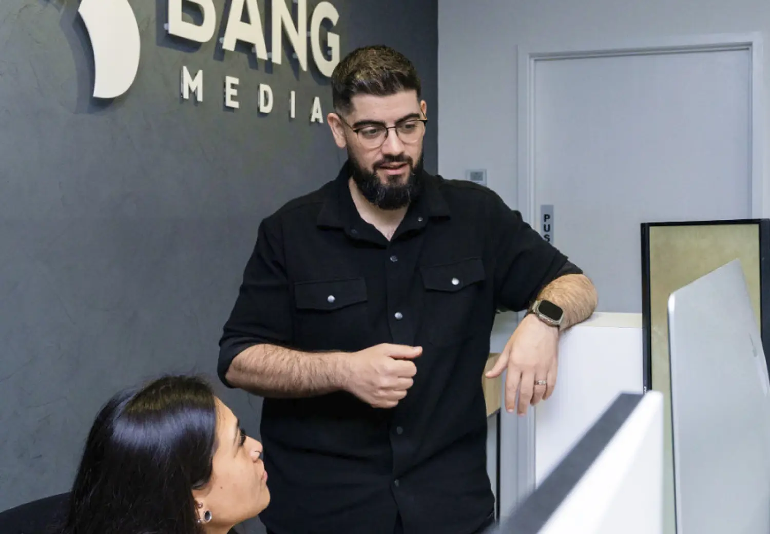 A man standing next to a woman in a room.
