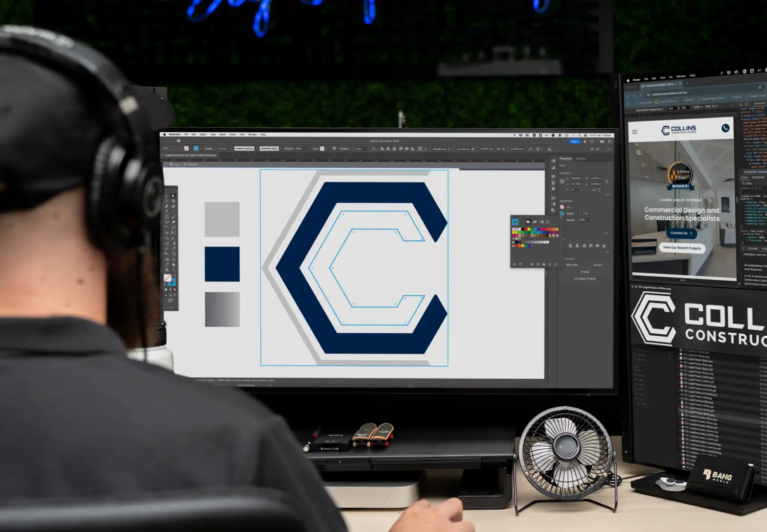 A man sitting in front of a computer monitor