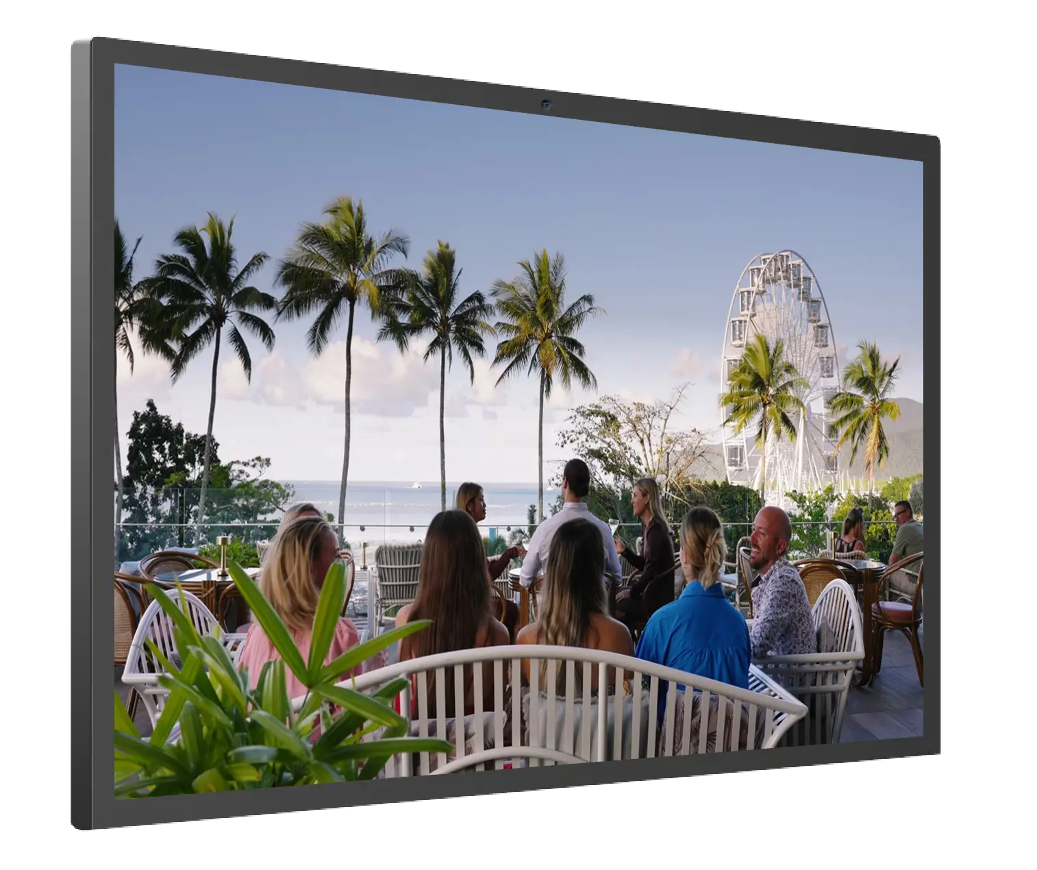 A group of people sitting at a table with a view of the ocean
