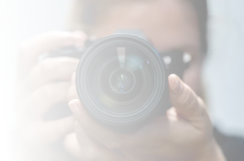 A man taking a picture of himself with a camera