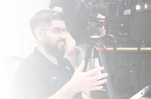 A man with a beard and glasses on a camera