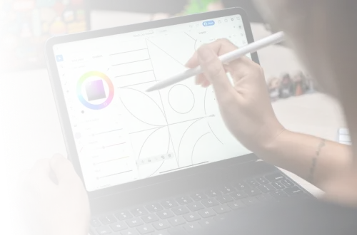 A woman is drawing on a laptop screen