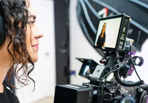 A man with headphones is recording a video