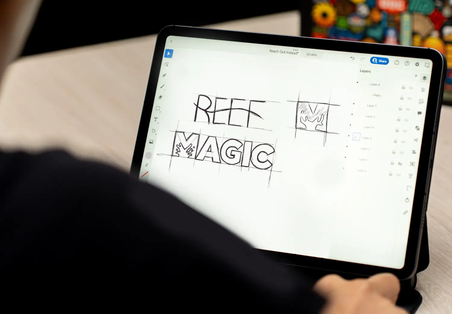 A person sitting at a table with a tablet