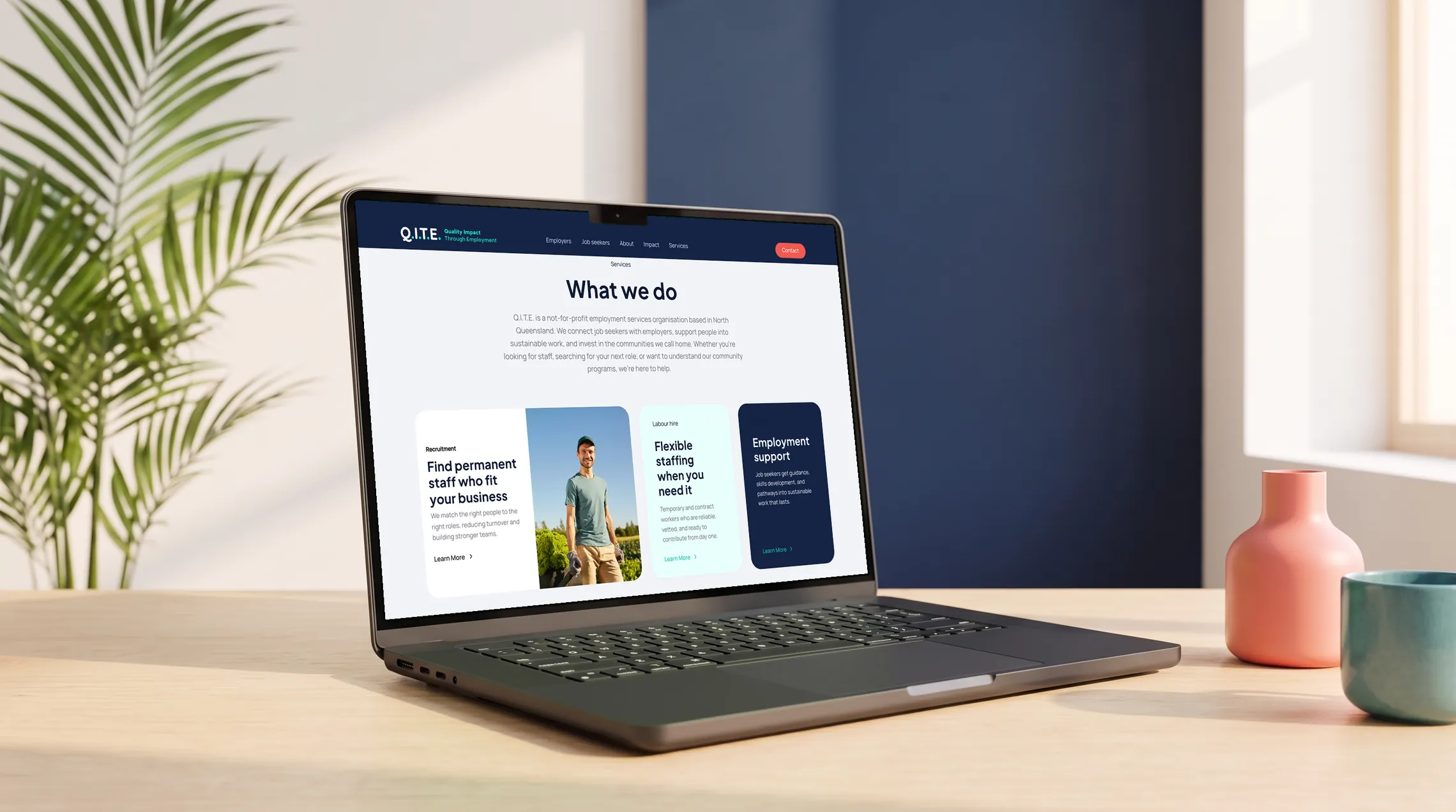 The Q.I.T.E. website What we do section on a MacBook Pro