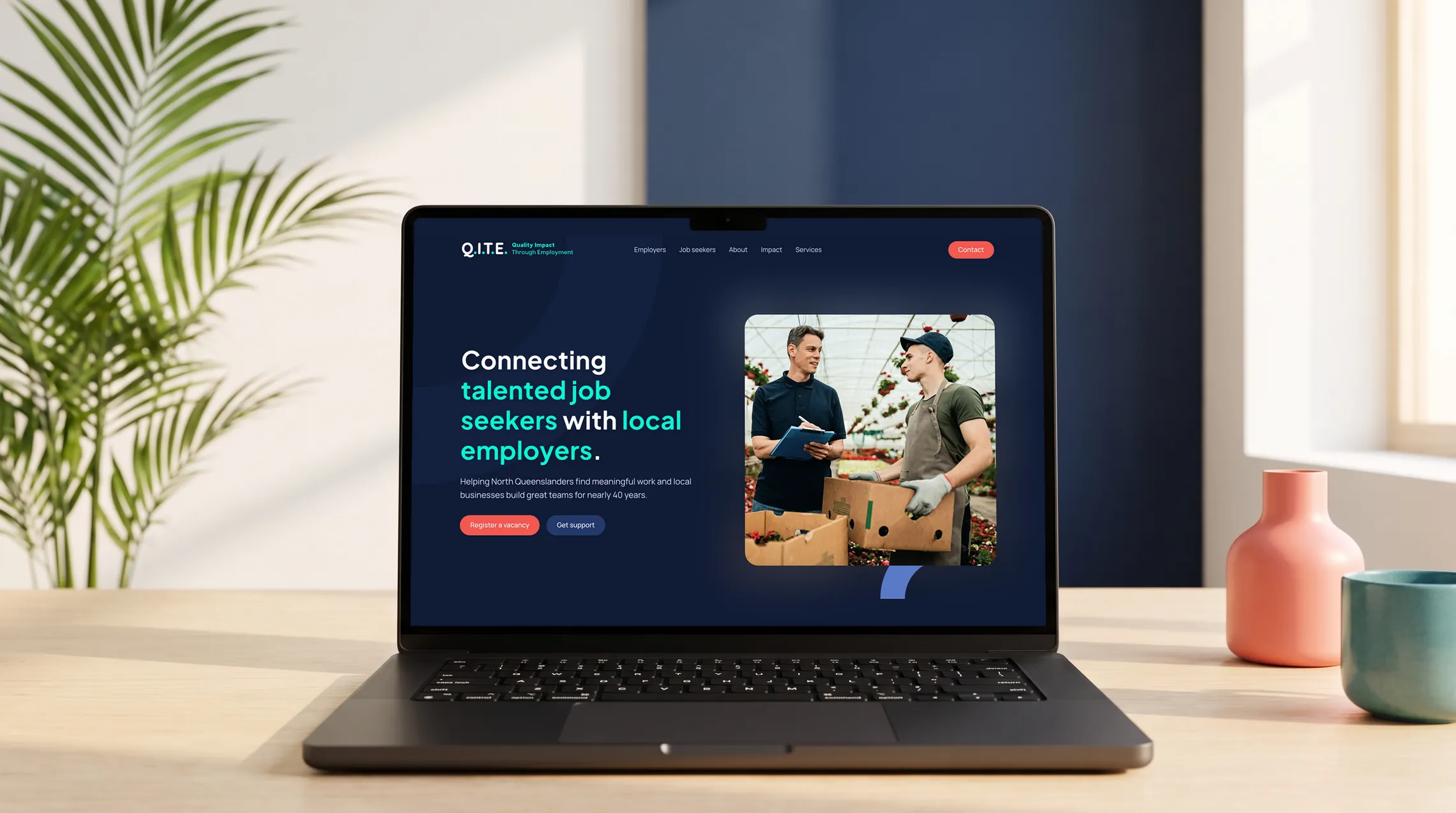 Q.I.T.E. website design by Bang Media, shown on a MacBook Pro
